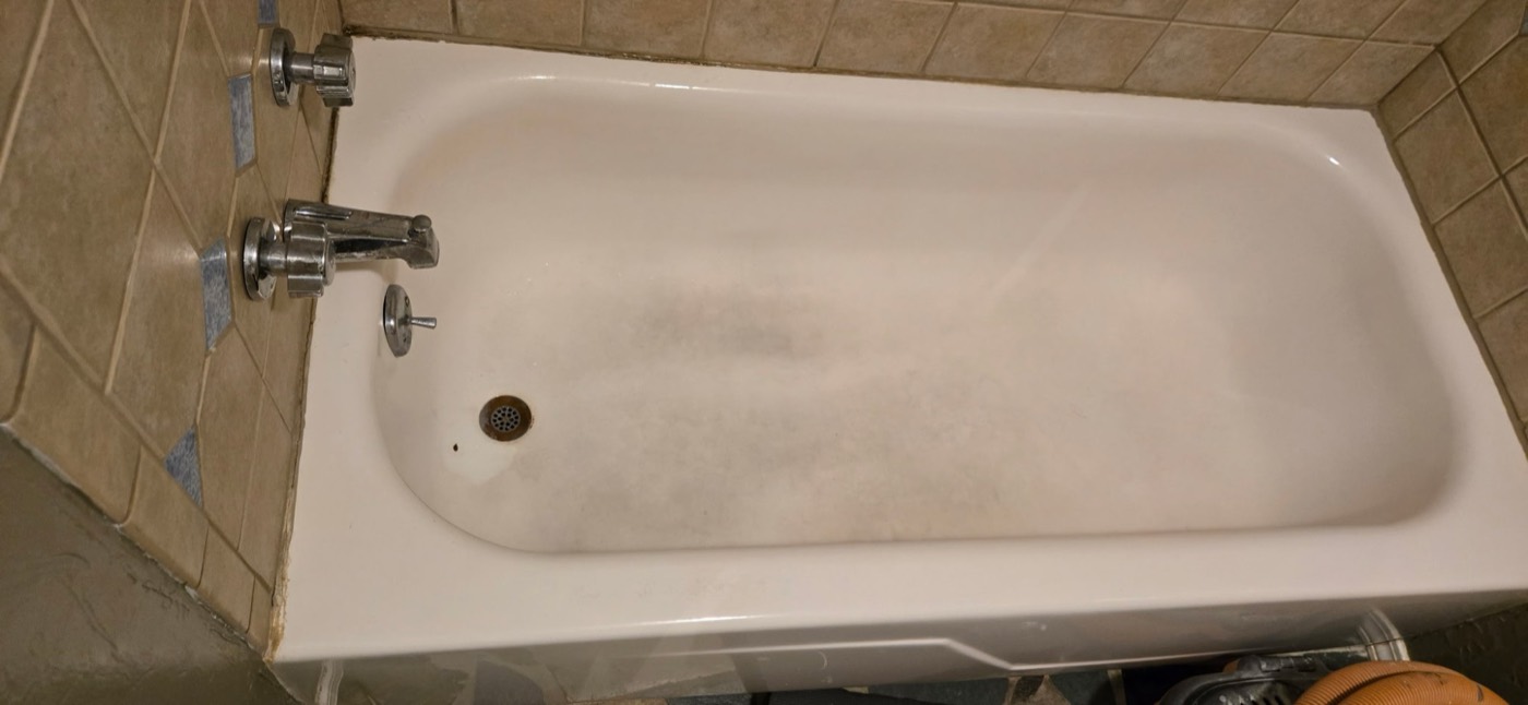 Stained, discolored steel bathtub before refinishing